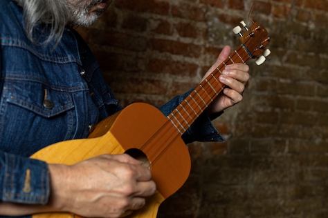 Man playing the Cuatro