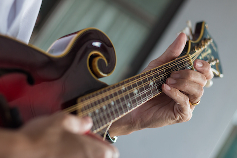 Female Guitarist Playing Acoustic Guitar