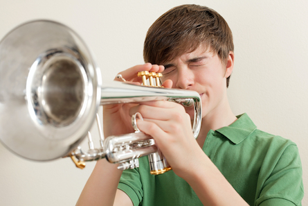 Teenage boy playing the trumpet